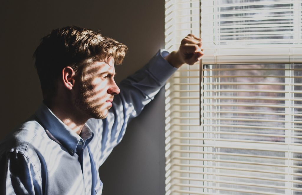 staring out the window after making a bad business decision about a home inspection mistake