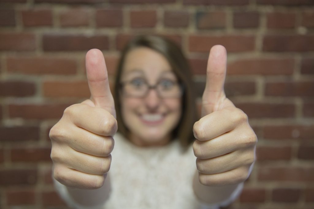 real estate agent giving a thumbs up to her home inspector