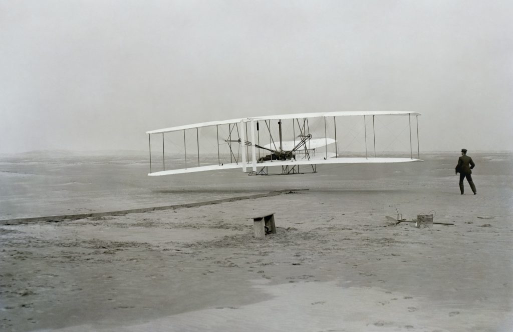 Wright brothers flying their plane to make it to their home inspection on time